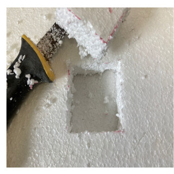 square hole in white styrofoam