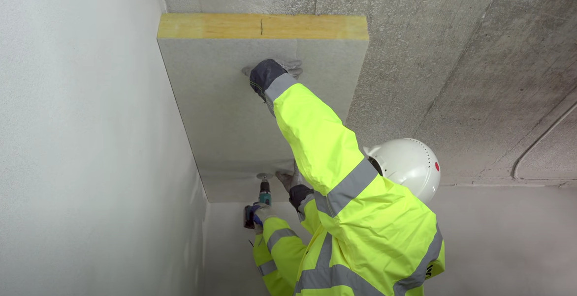 man fixing soffit slab to concrete ceiling
